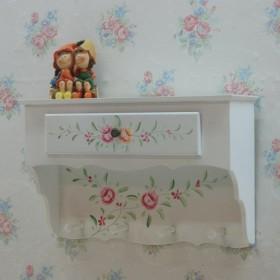 White wall shelf with hooks